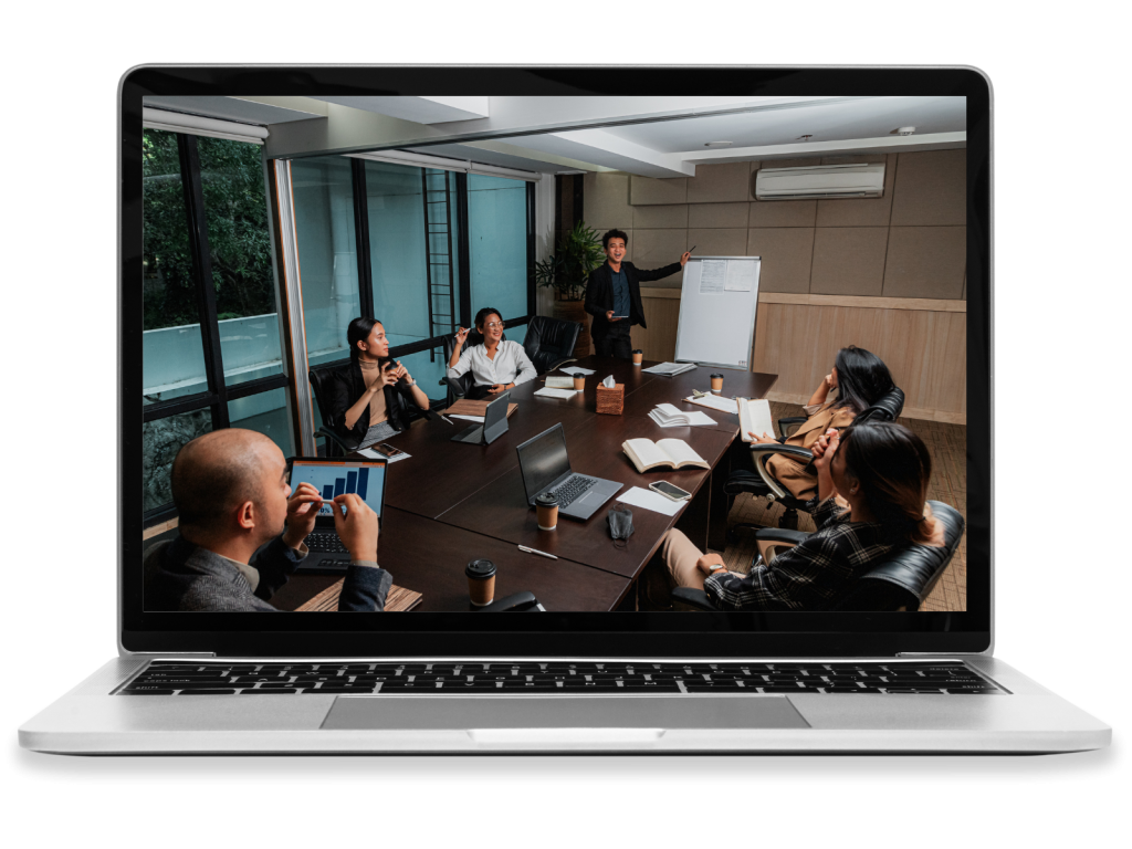 A business meeting as a man pitches an idea on a whiteboard.