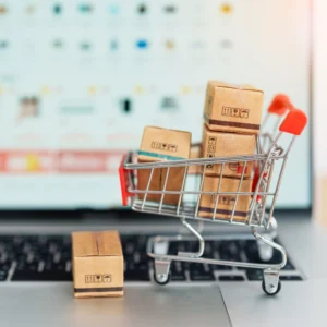 A miniature shopping cart with cardboard boxes.