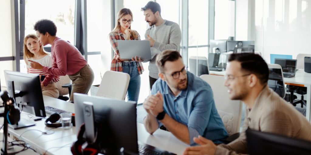 An IT consulting team collaborating in a modern office