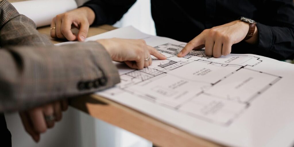 An architectural specialist pointing at a diagram.